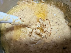 Folding corn oil into the cake batter