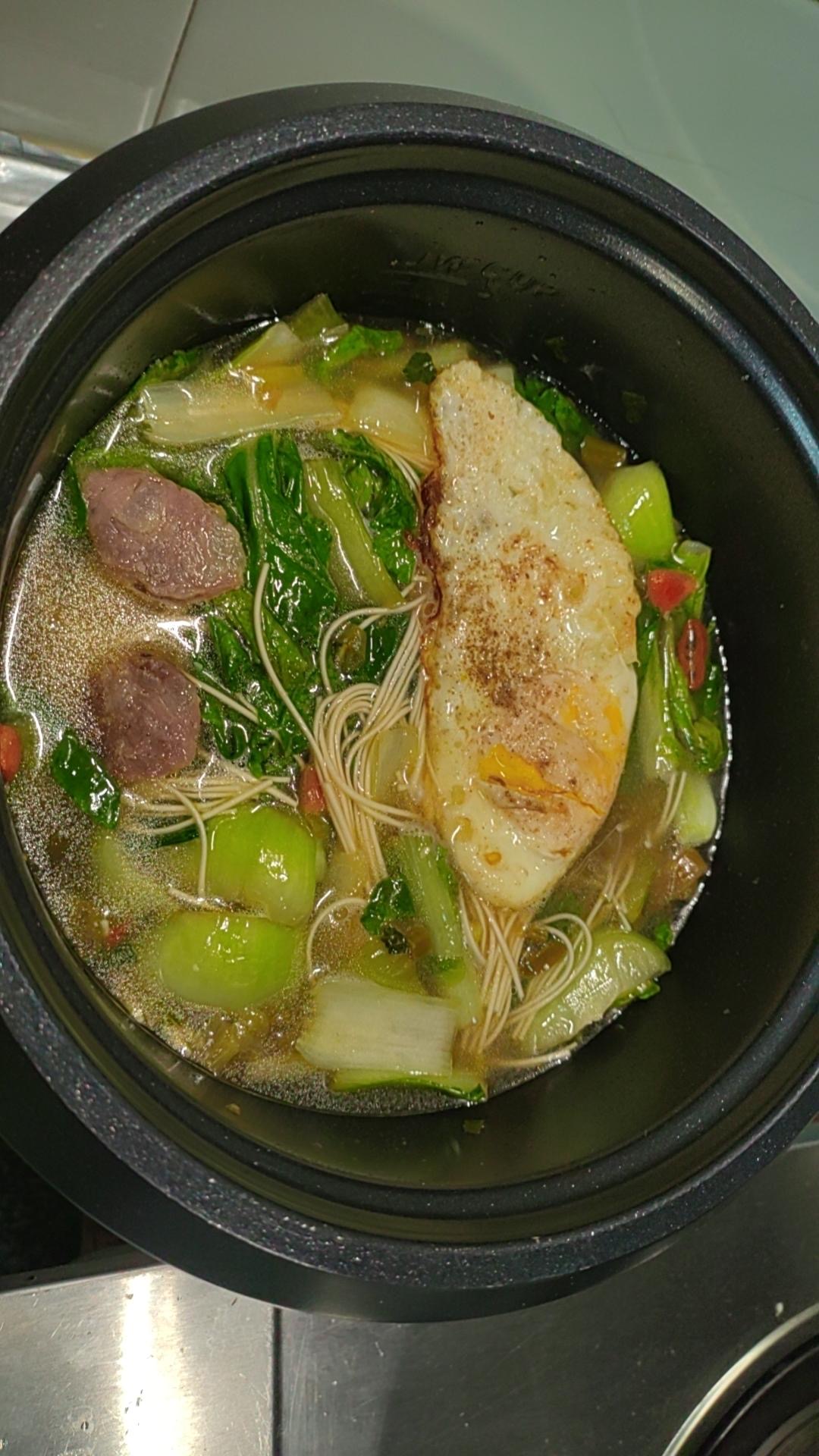 Rice cooker sausage veggie noodles in a bowl with Chinese sausage, napa cabbage, and thin noodles