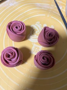 The dough log cut in half to form two roses