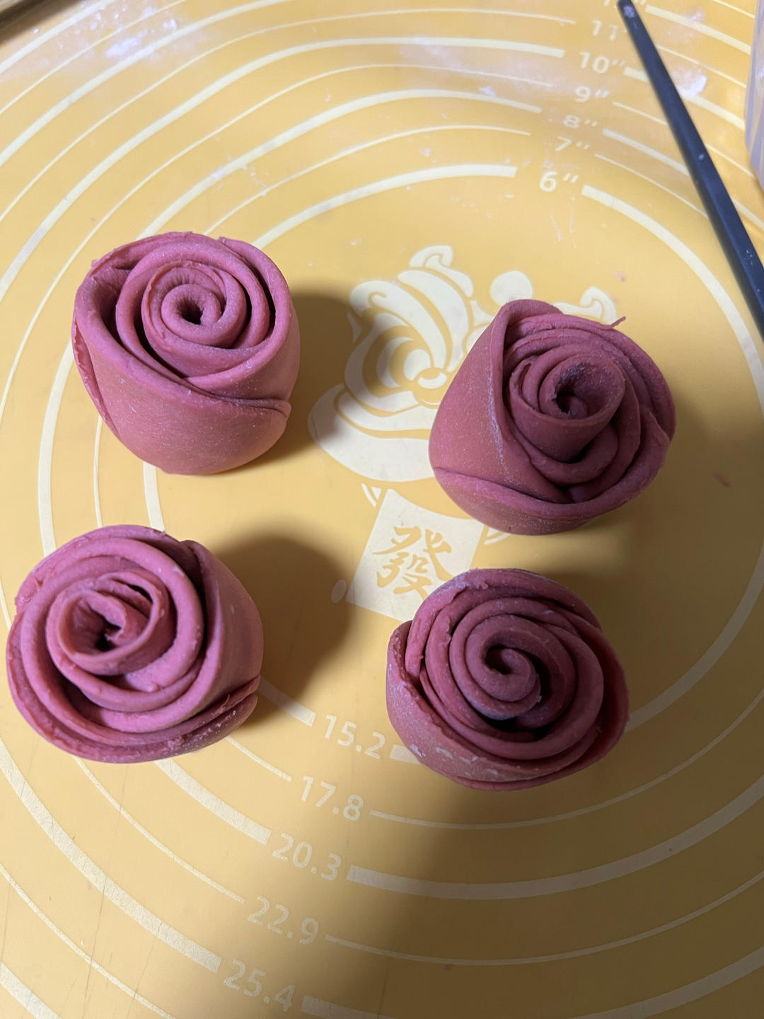 The dough log cut in half to form two roses
