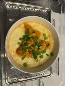 Blanketing the custard with fresh sea urchin