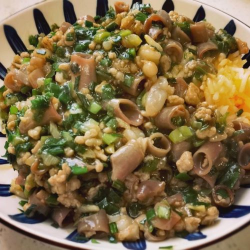 Sea worm rice bowl with golden egg fried rice topped with shrimp, pork, and sea worms