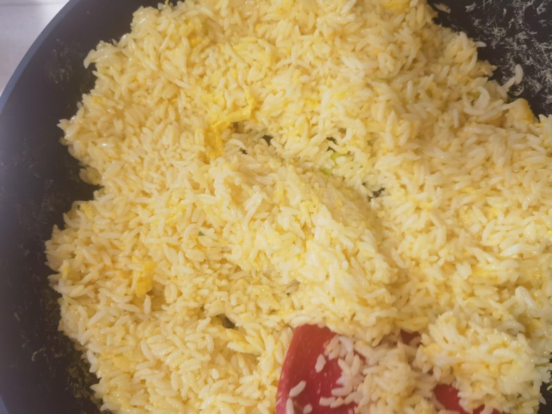 Golden egg fried rice in a wok