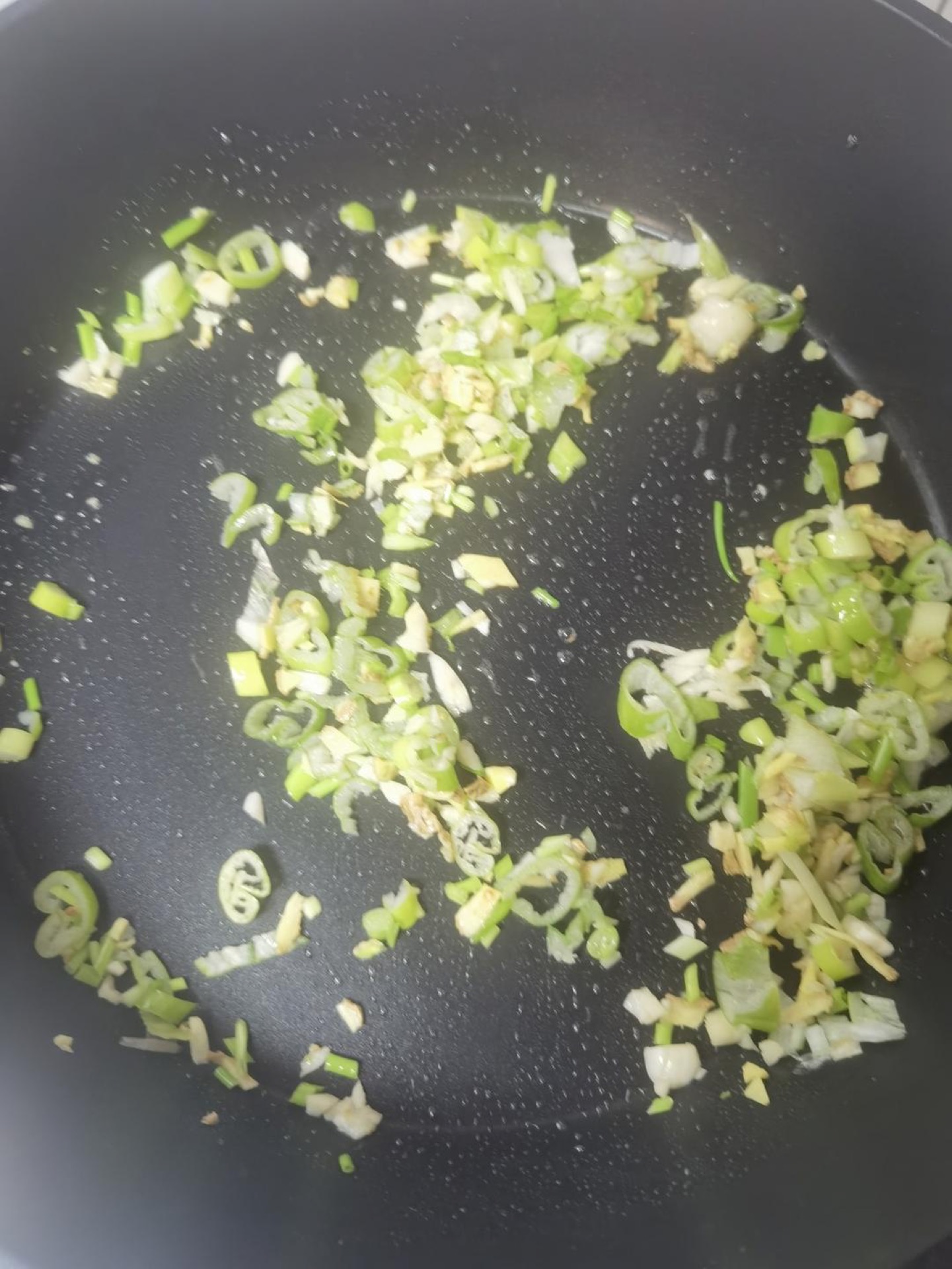 Aromatics sizzling in a wok
