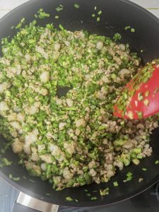 Sea worm and chive mixture glossy with sauce in a wok