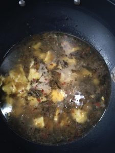Once the eggs are cooked through and the pickles smell tangy, pour in the water and let the broth come to a simmer.