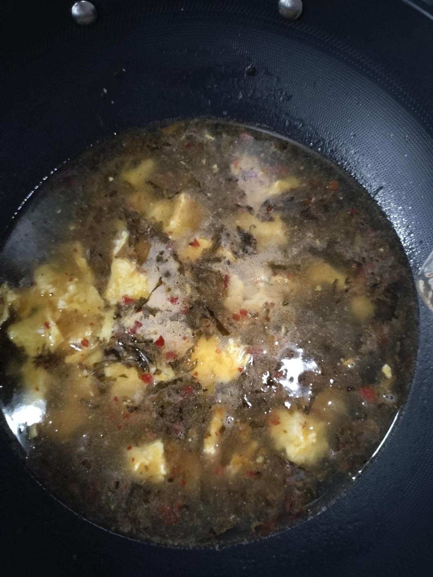Once the eggs are cooked through and the pickles smell tangy, pour in the water and let the broth come to a simmer.