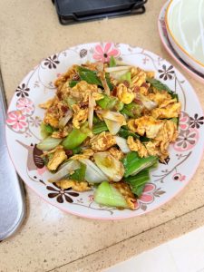 Return the eggs, pour in the sauce, and stir-fry over high heat until the sauce thickens, coats the eggs, and smells fragrant, then slide everything onto a plate.