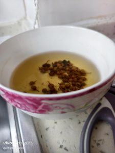 Sichuan peppercorns steeping in a bowl of hot water