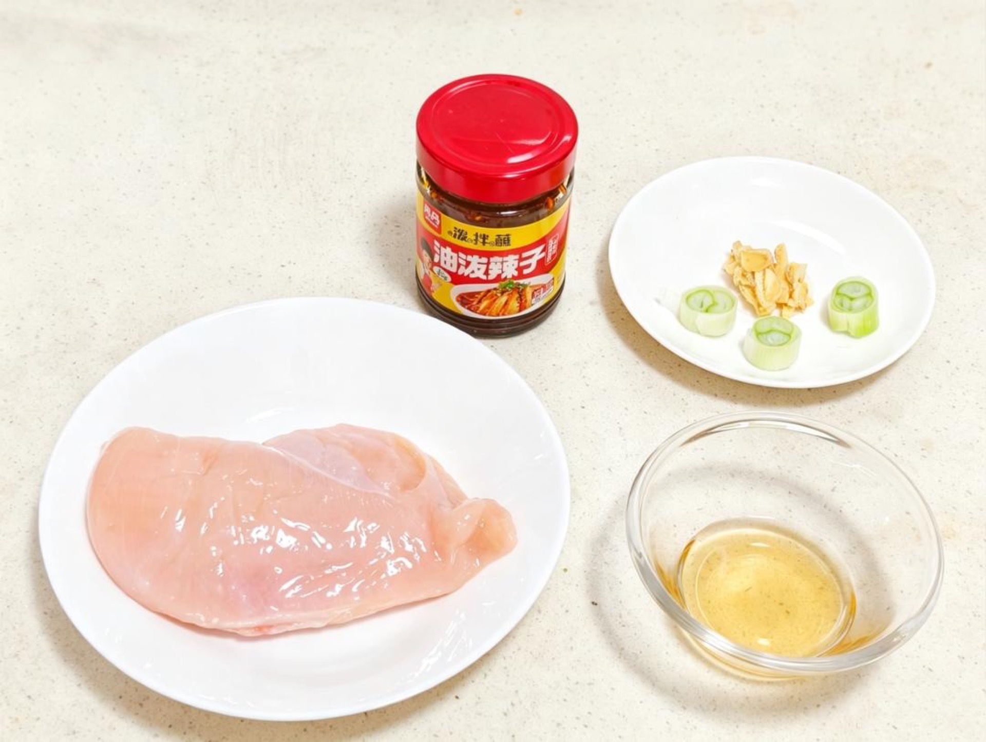 Set out the chicken breast, ginger, scallion, Shaoxing wine, cucumber, carrot, egg, and all the dressing ingredients so everything is within reach before you start.