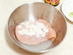 Sprinkle the flour over the chicken breast and rub it in with your hands, working the flour into the surface, then rinse the breast thoroughly under cold running water and pat it d