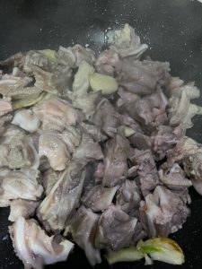Stir fry until the pork cartilage surface turns glossy with rendered oil
