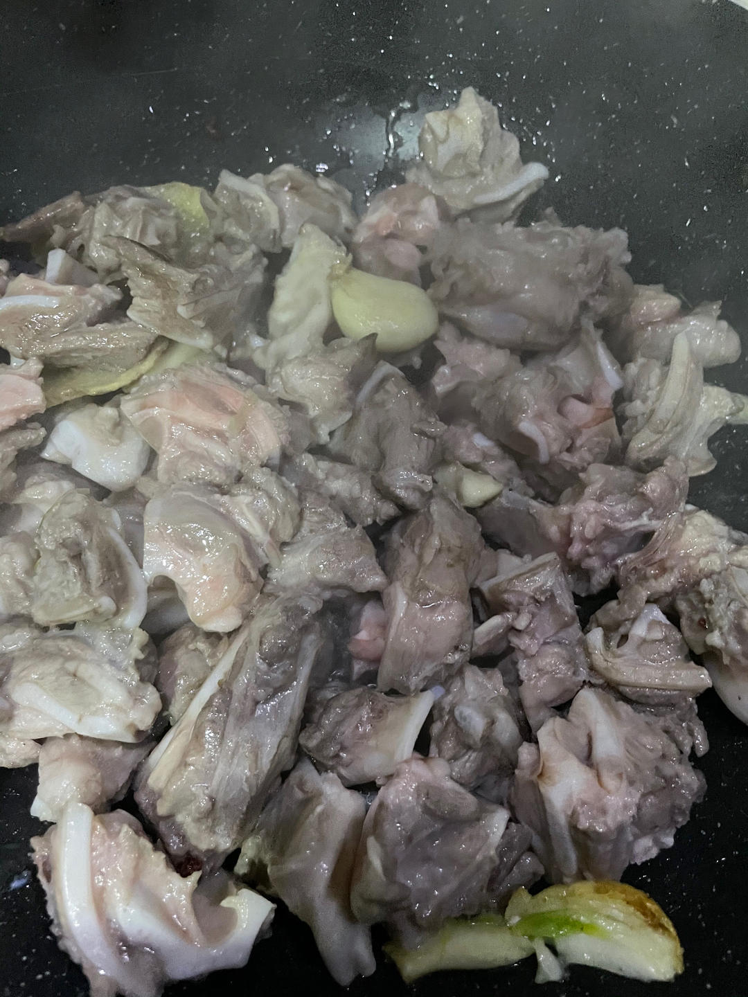Stir fry until the pork cartilage surface turns glossy with rendered oil
