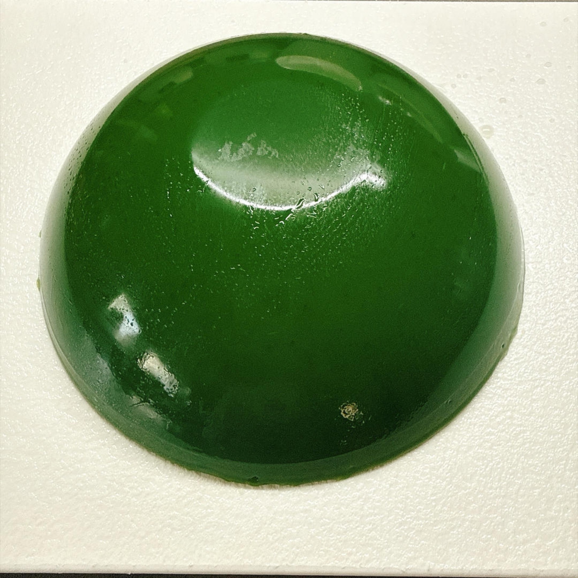 It flops out with a soft thud, a big translucent green block that wobbles like jelly and begs to be bitten.