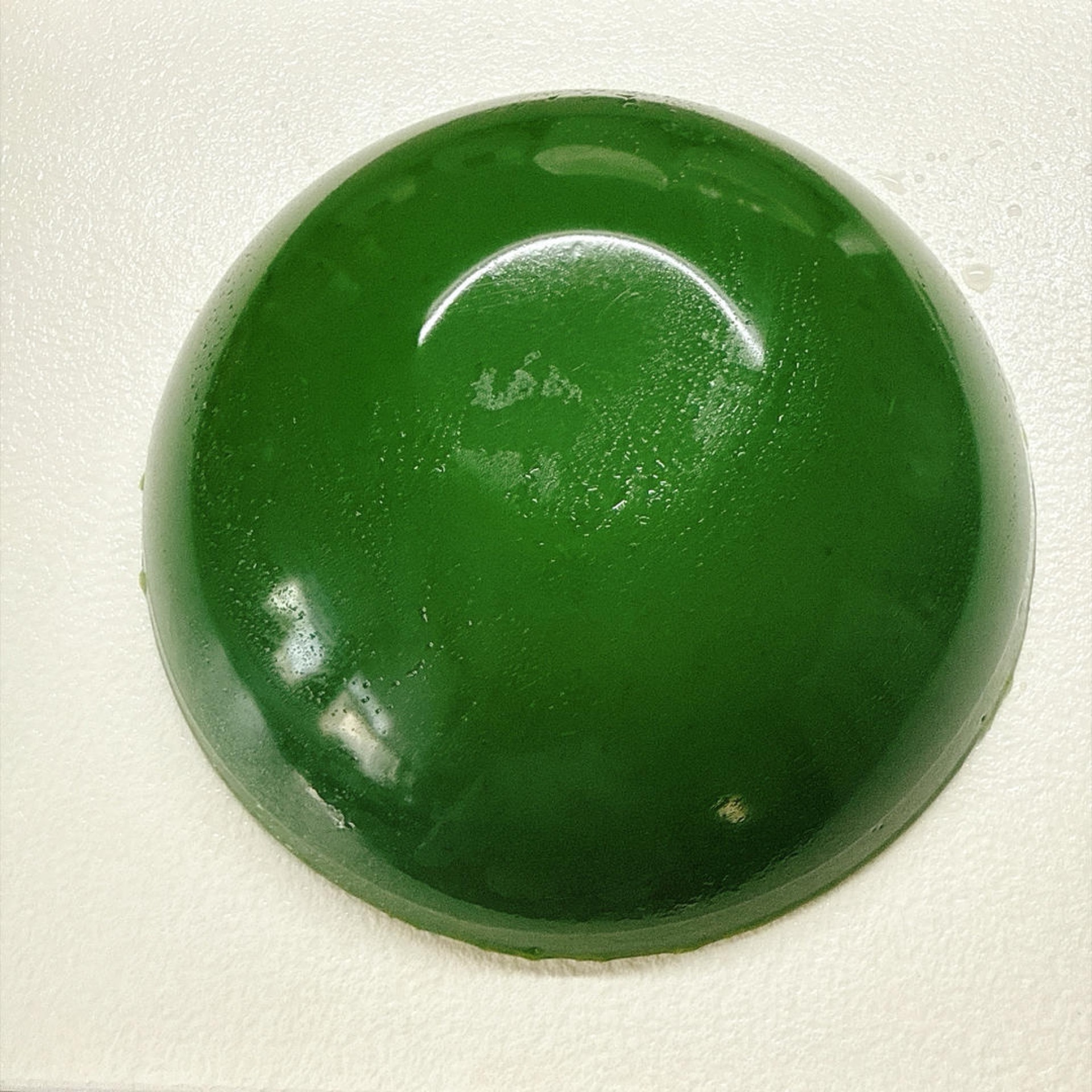 Emerald and glistening, like a block of clear jade — cooling just to look at.