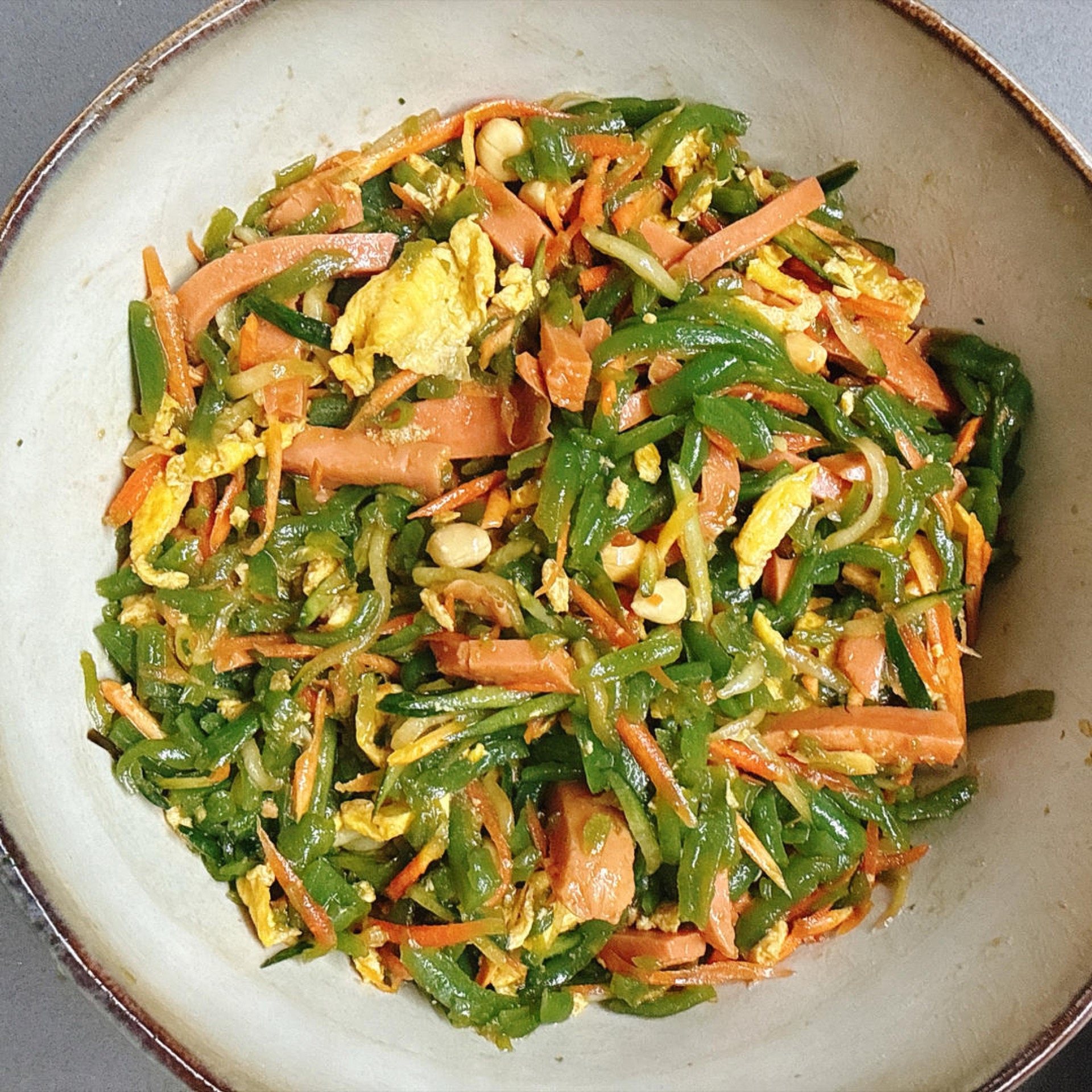 Season however you like — I added shredded omelet, ham, cucumber, carrot and roasted peanuts.