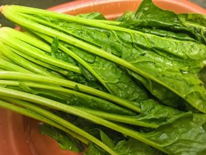 Spinach washed in a bowl of water