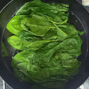 Bring a pot of water to a boil and blanch the spinach for about one minute; this step cannot be skipped.
