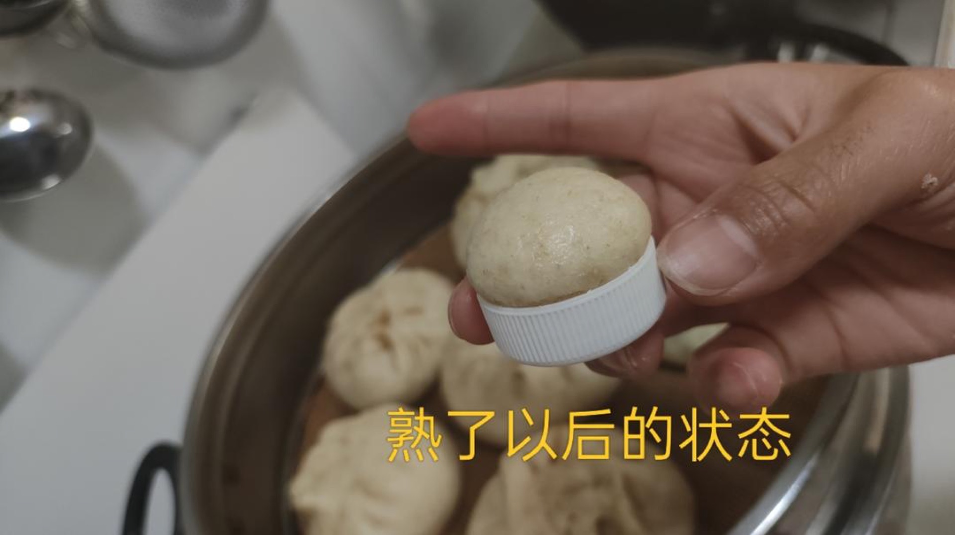 Cooked lid bun showing how much it puffed during steaming