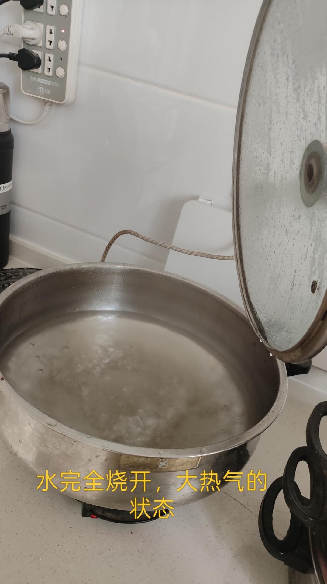 Pot of water at a rolling boil with steam rising