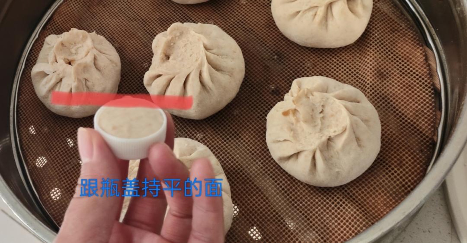 Small flattened piece of dough set aside as a proofing indicator