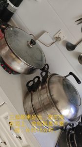 Stacked steamer tiers resting on the table to proof