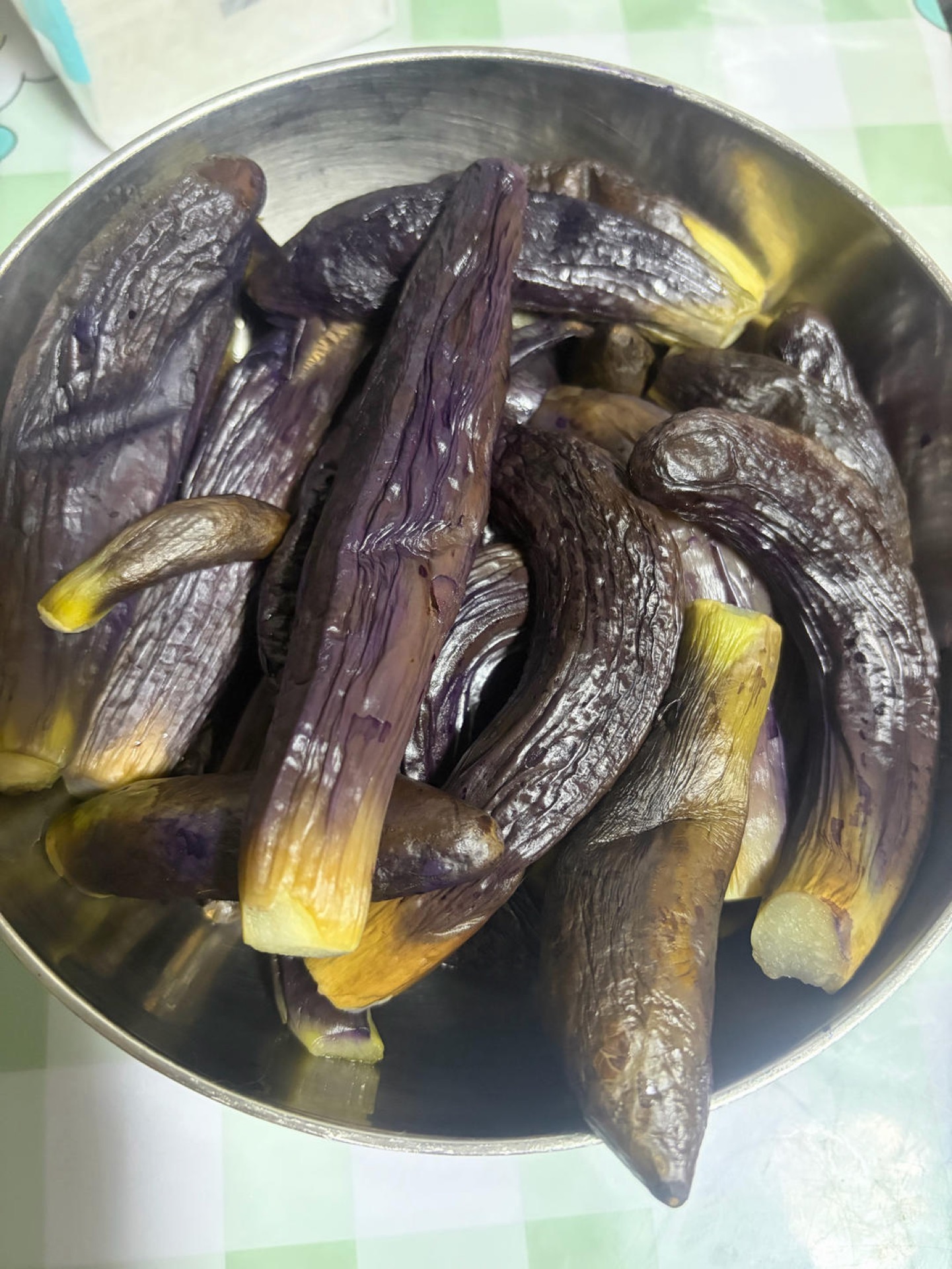 Steam the eggplants — the smaller ones are best — in the same steamer, about 10 minutes after the water comes back to a boil.