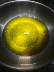 Add oil to the wok — use plenty, because too little oil makes the sauce spoil faster.
