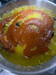Then add two tablespoons of light soy sauce for freshness, add the cooked soybean paste, and add 10 tablespoons of salt — adjust to your own taste, since more salt means the sauce