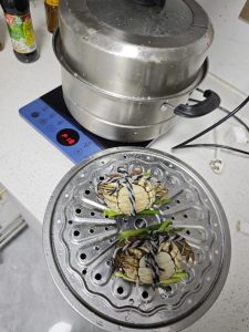 Crabs steaming in a covered pot