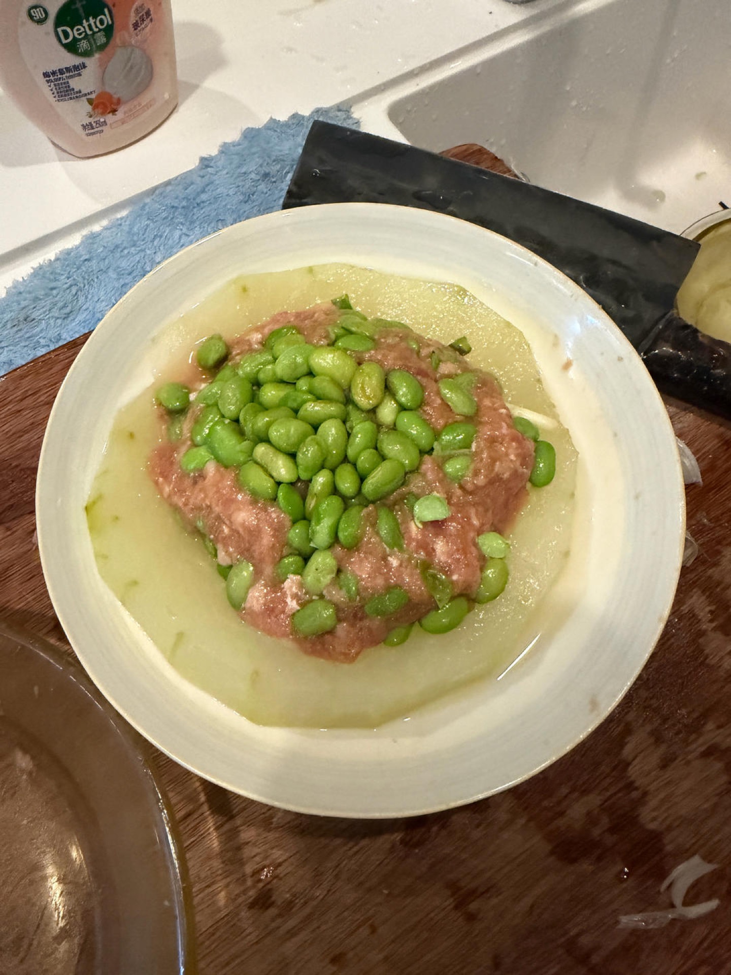 Scatter the steamed edamame over the top of the pork filling.