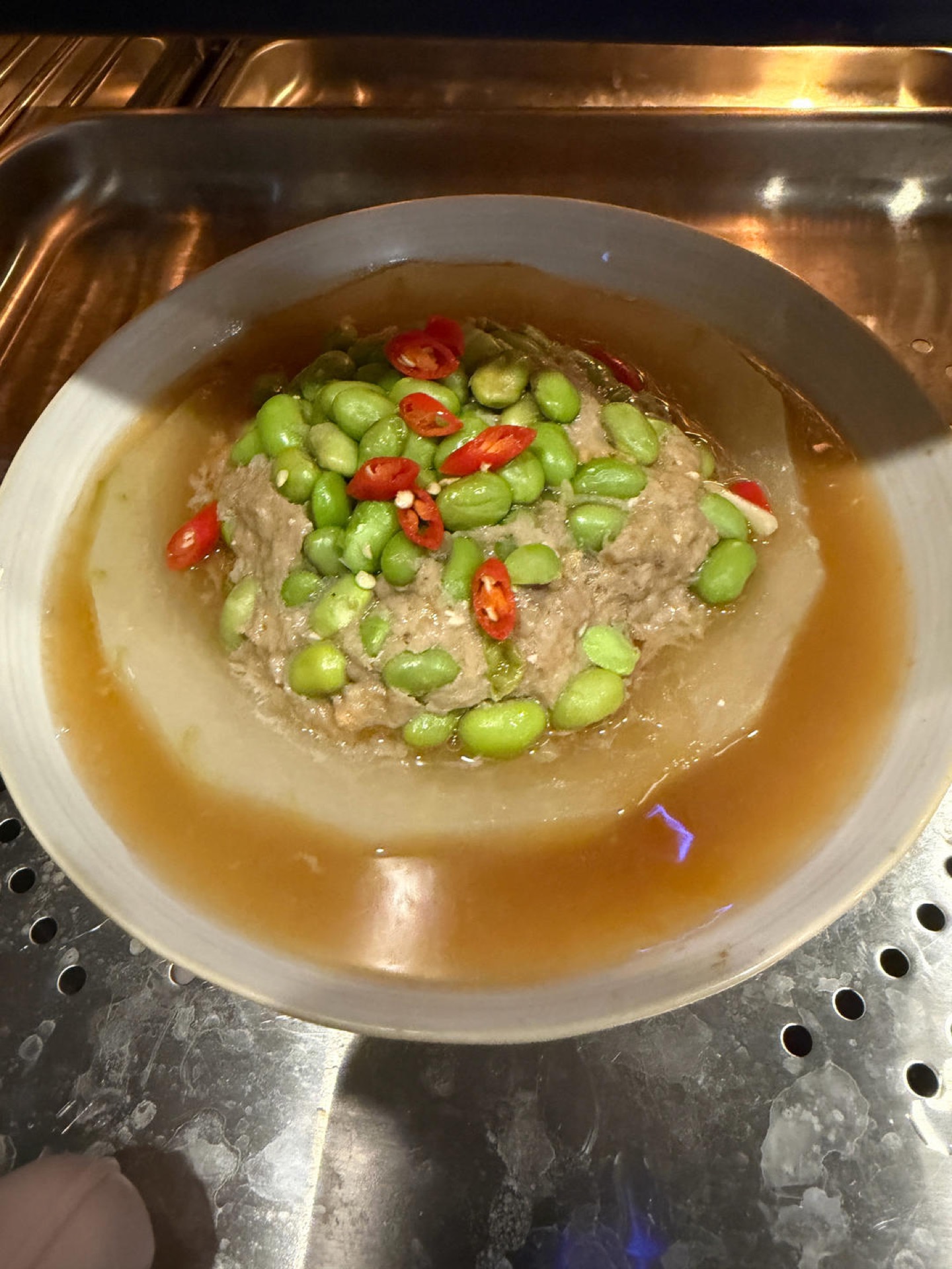 Scatter sliced bird's eye chili over the top for color. Leave the chili out if you are serving children.
