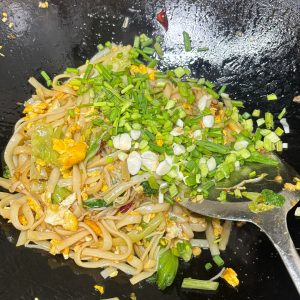 Stir fried ho fun noodles with egg bean sprouts and greens