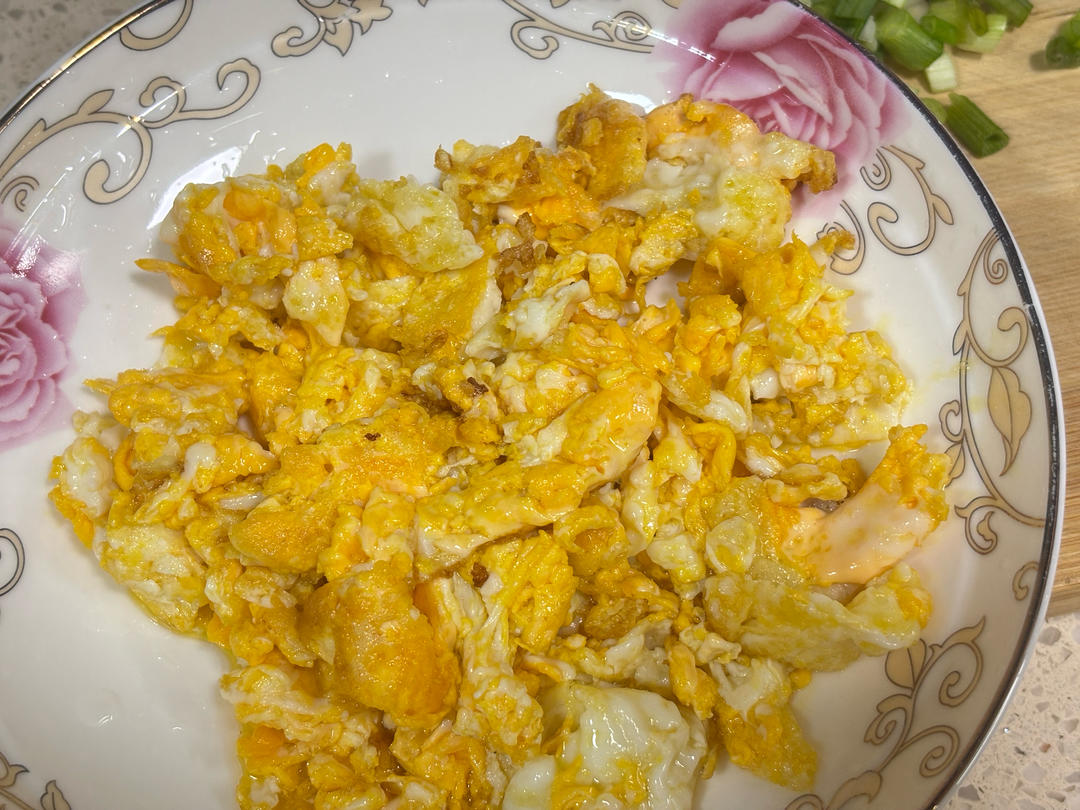 Setting the cooked egg aside on a plate
