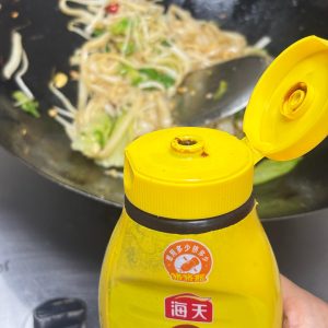 Adding oyster sauce to the glazing noodles