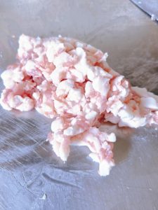 Minced pork belly being folded into minced pigeon