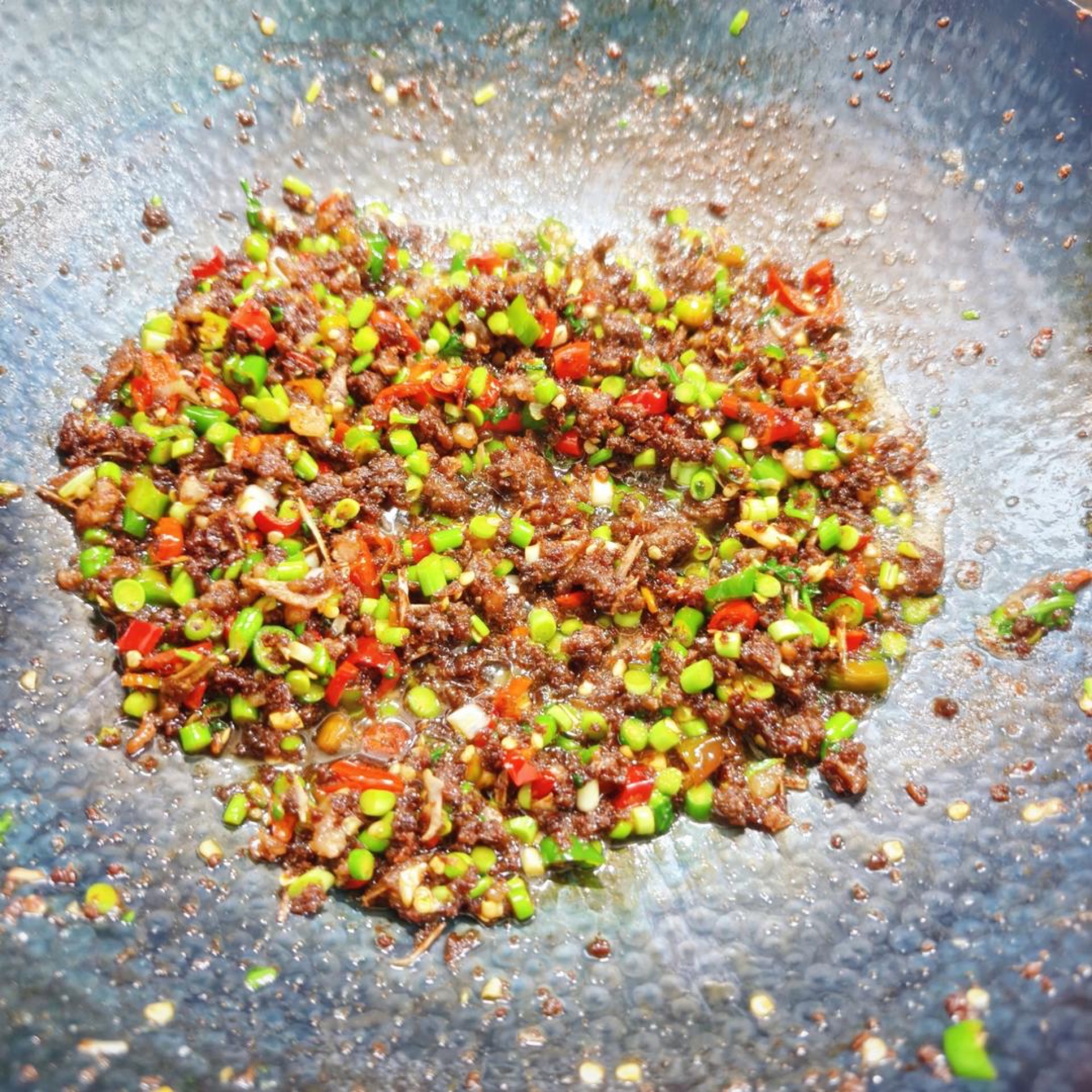 Cilantro being tossed into the hot wok at the last second