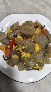 Finally add the scallion sections, stir once more to combine, and turn it out onto a plate to serve.