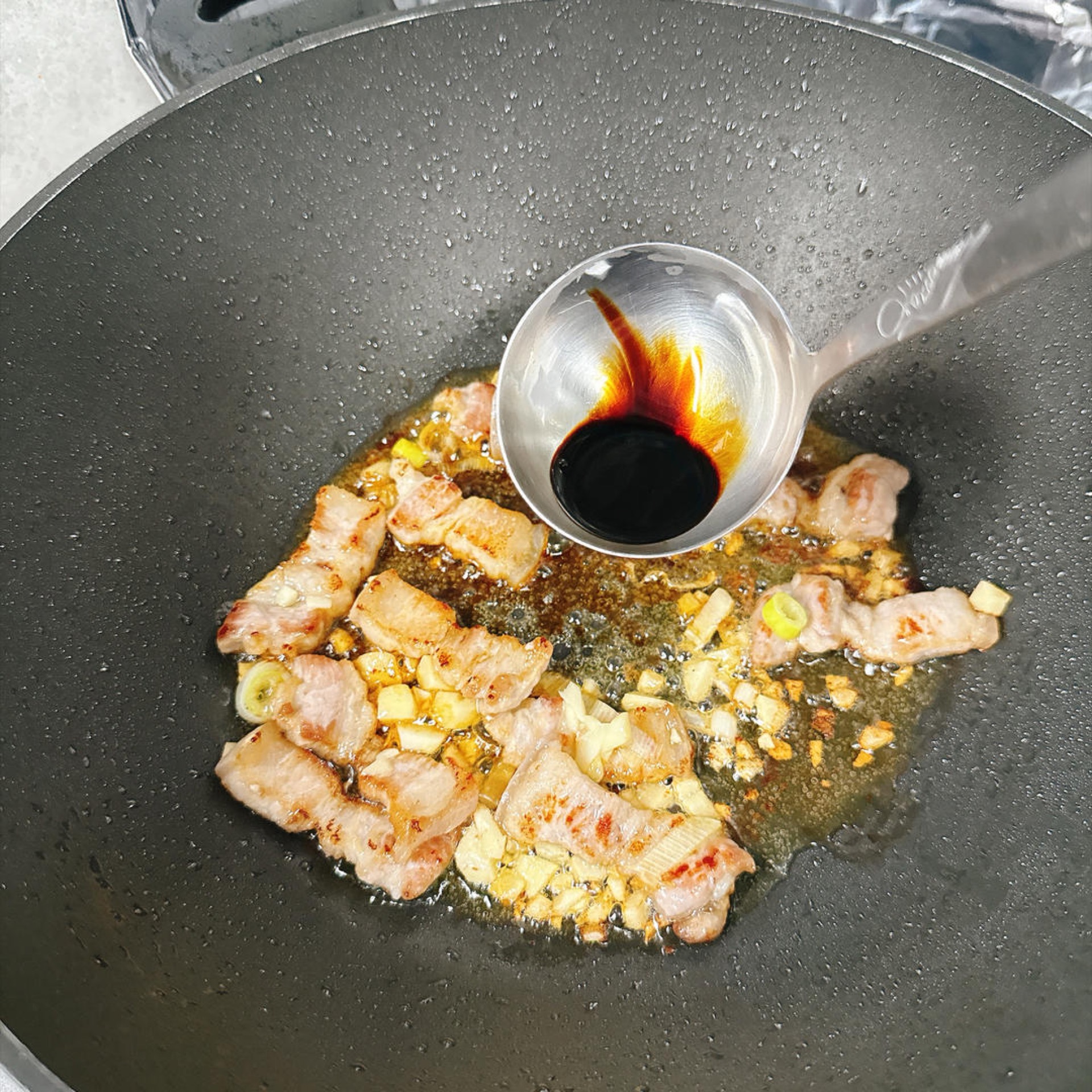 Add a little dark soy sauce — not too much, just enough for color — and stir until it blends in.