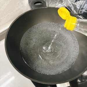 Bring a pot of water to a boil and add a little white vinegar.