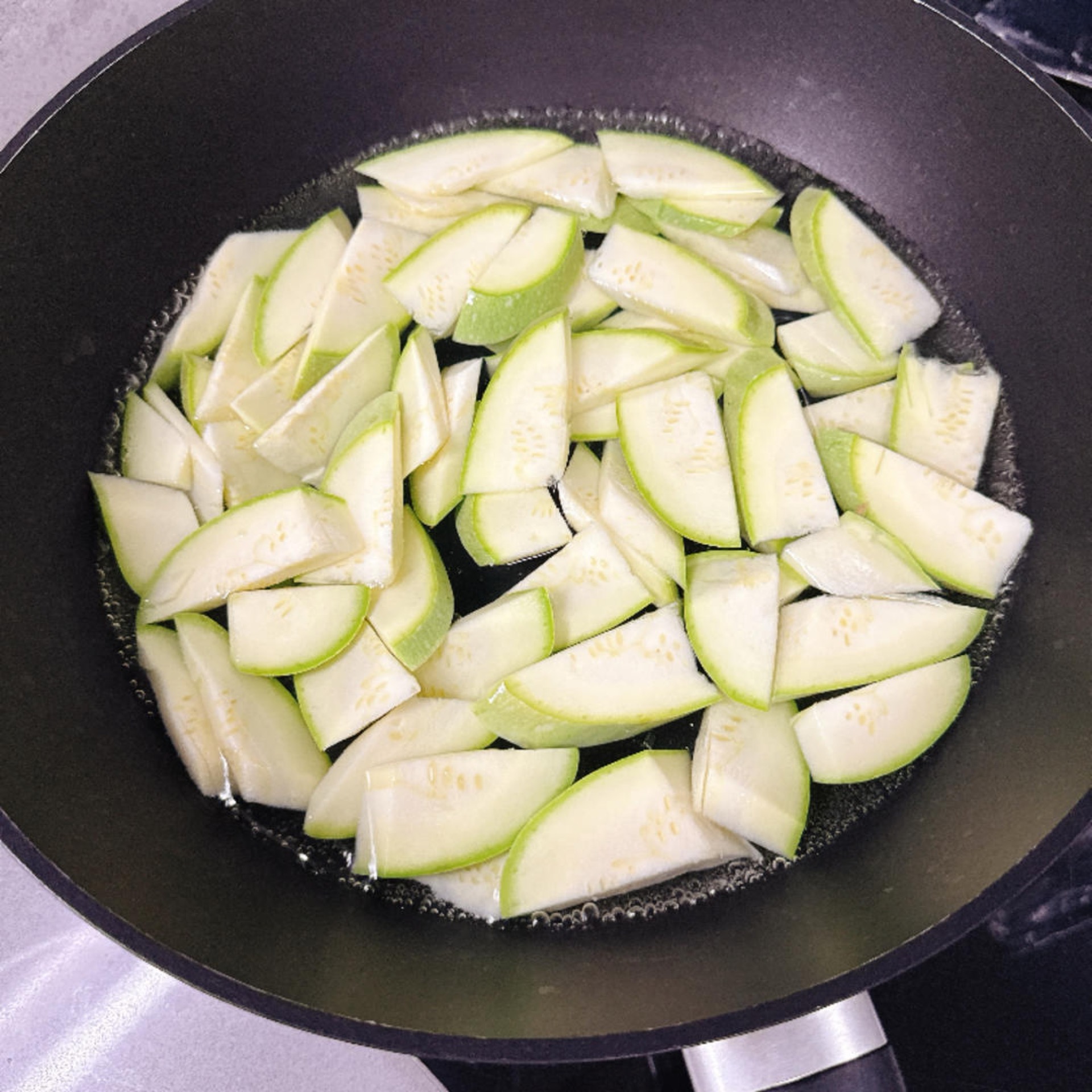 When the water returns to a boil, add the zucchini and blanch it briefly.