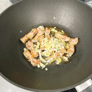 Add the chopped scallion and garlic and stir until fragrant.