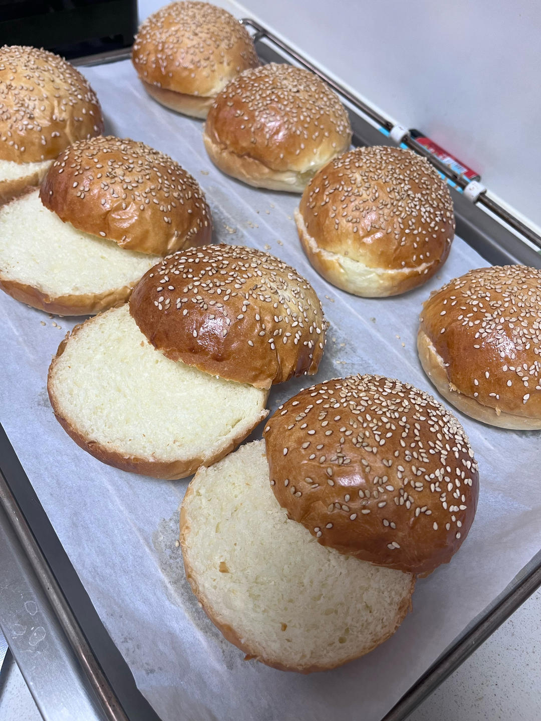 Golden sesame-dotted tangzhong burger buns fresh from the oven