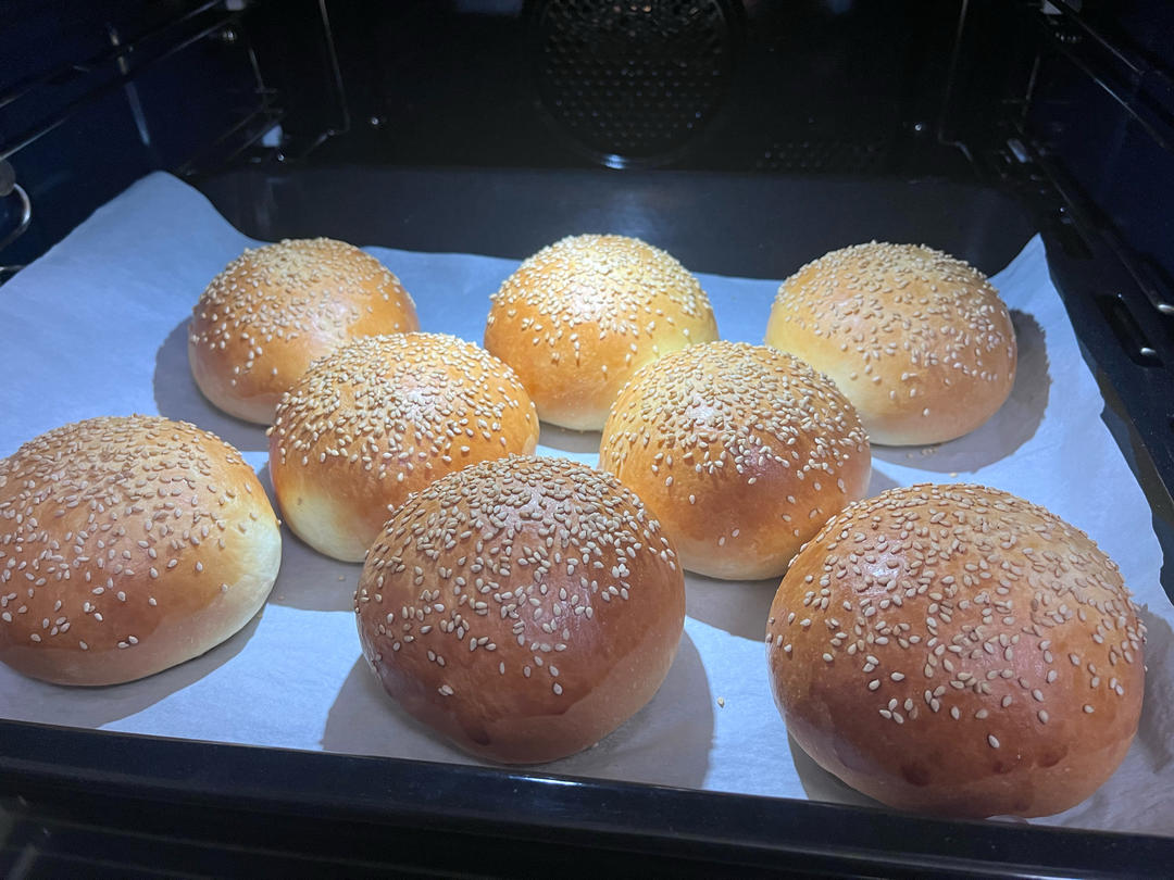 Golden tangzhong burger buns baking in the oven