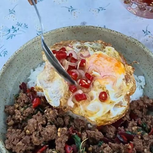 Thai basil pork rice with a crispy fried egg and chili fish sauce