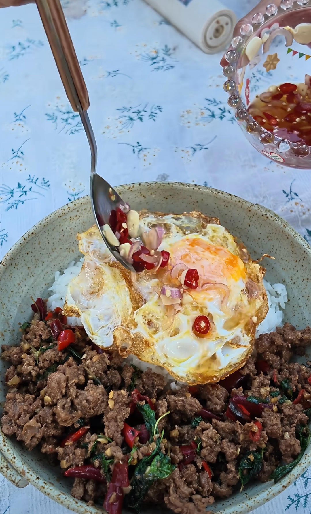 Thai basil pork rice bowl with egg and chili fish sauce