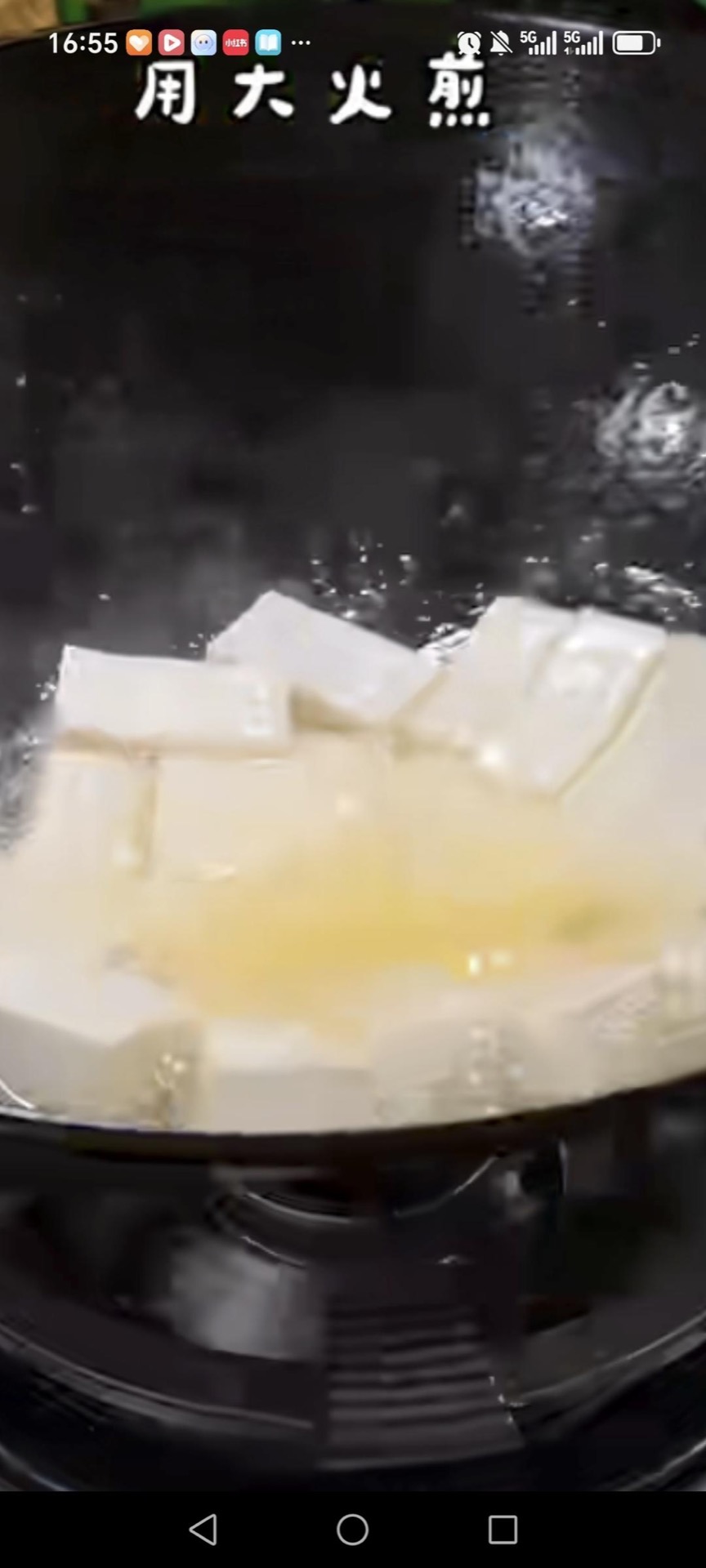 Add the tofu cubes to the pan and fry them gently.