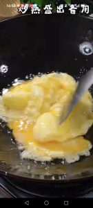 Heat a second pan with oil over high heat, pour in the 2 beaten eggs and fry them until set, then remove and set aside.
