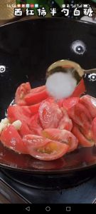Add the tomatoes to the pan and pour in the half spoonful of sugar.