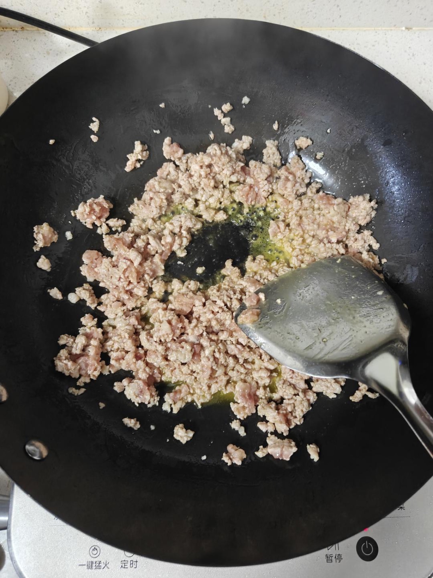 Heat the wok over medium-high heat, add the cold oil, and stir-fry the ground pork until it is fragrant and no longer pink, about 3 minutes.